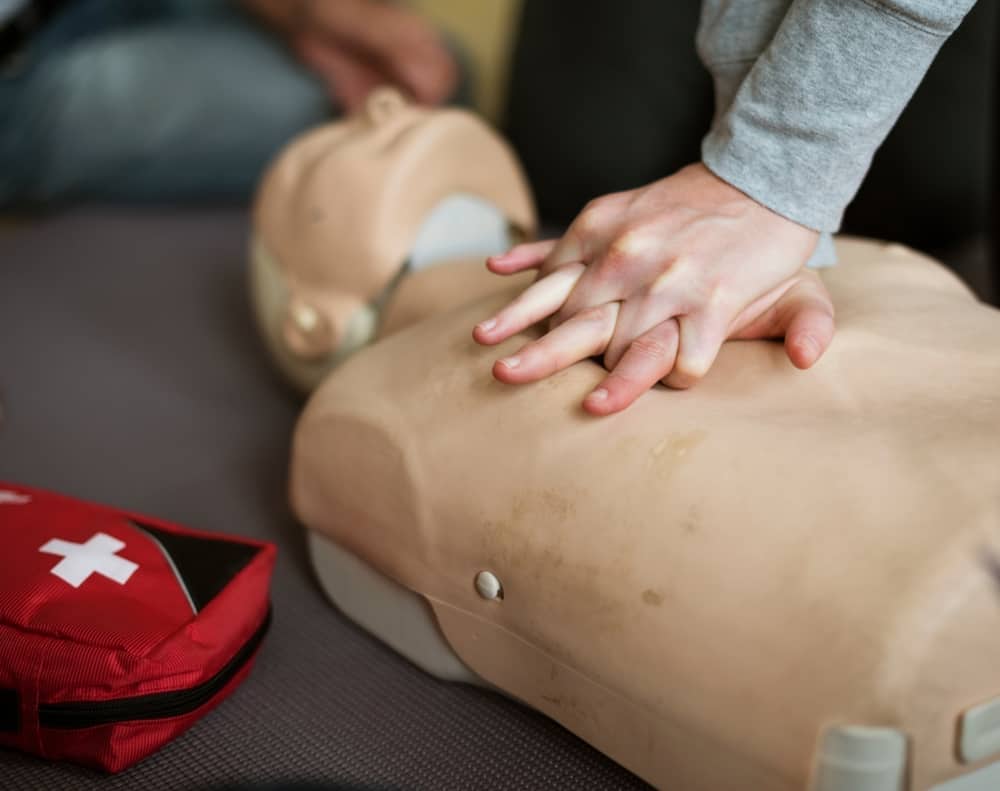 First-aid training giving CPR to dummy
